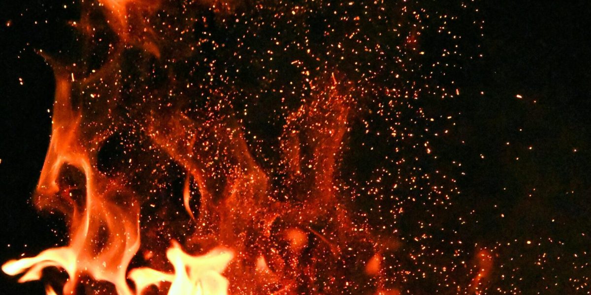 pexels-photo-1558916-1558916 Vivid orange flames and sparks dance against a mysterious black backdrop.